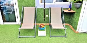 two chairs on a lawn with a bowl of fruit at Vintage Meson Ocean View in Adeje