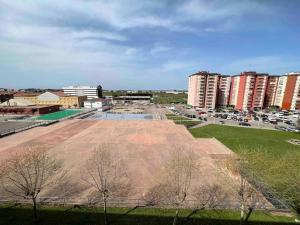 a large empty field in a city with tall buildings at Apartamento en Santander in Santander