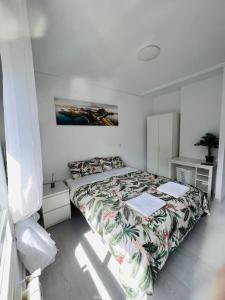 a bedroom with a bed with a bedspread on it at Apartamento en Santander in Santander
