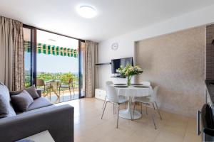 a living room with a couch and a table at Las Americas Acapulco 4 Costa Adeje in Playa Fañabe