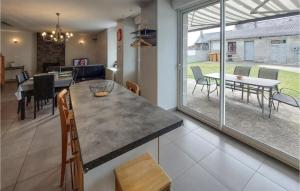 a kitchen and dining room with a table and chairs at Awesome Home In La Maugon With Kitchen 