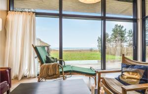 a room with a large window with chairs and a table at Gorgeous Home In Ebeltoft With Kitchen in Ebeltoft