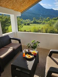 a living room with a table with a bowl of food on it at Sunny Valley Retreat near Skadar Lake in Virpazar