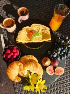a table with a plate of breakfast foods and a glass of orange juice at Sunny Valley Retreat near Skadar Lake in Virpazar +13 photos