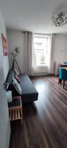 a living room with a couch and a large window at Location Location Location, Whole apartment for you! in London