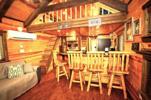 a kitchen with a bar in a log cabin at The Codex - Parker Creek Bend Cabins in Murfreesboro