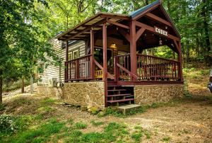 a small cabin in the middle of a forest at The Codex - Parker Creek Bend Cabins in Murfreesboro