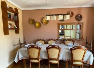 a dining room with a table with chairs and a mirror at Casa Rural Galain Ultzama-Navarra in Lizaso