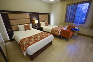 Postel nebo postele na pokoji v ubytování Athena Hotel Kampala
