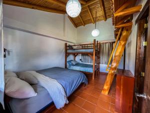 a bedroom with two bunk beds in a room at Vistabamba Ecuadorian Mountain Hostel in Vilcabamba