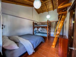 a bedroom with two bunk beds in a room at Vistabamba Ecuadorian Mountain Hostel in Vilcabamba
