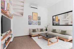 a living room with a couch and a table at Fliphaus Santa Fe 5100 - 3 Bd Pool & Bbq in Buenos Aires