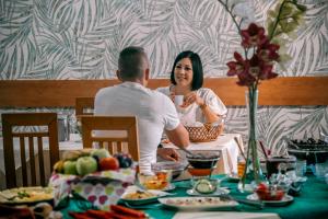 a man and a woman sitting at a table at Aqua Therm Hotel in Zalakaros