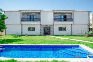 a house with a swimming pool in front of it at Residence Eliz in Kabrousse