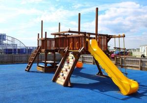 a playground with a yellow slide and a slideintend at GB36 in Chapel Saint Leonards