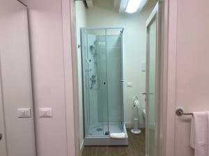 a glass shower in a bathroom with a toilet at Piccolo Borgo Antico in Brescia