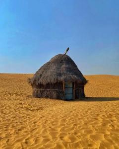 a small hut in the middle of the desert at Hotel haritage desert safari in Jaisalmer
