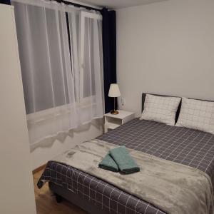 ein Schlafzimmer mit einem Bett mit einem grünen Handtuch darauf in der Unterkunft Ośrodek Wypoczynkowy Zakątek in Kąty Rybackie