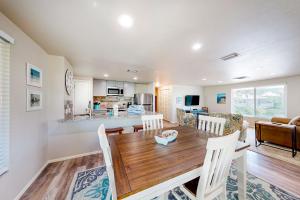 a kitchen and living room with a wooden table and chairs at South Bay Inn 4 in Anna Maria