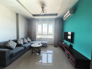 a living room with a couch and a tv at Ngọc Duyên Homestay- Central Vung Tau, near Lotte Mart in Vung Tau