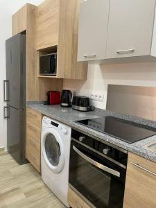 a kitchen with a washer and a stove top oven at Perpignan Centre : Superbe appartement en Roof-top in Perpignan