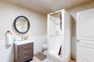 a bathroom with a sink and a toilet and a mirror at Hidden Valley Haven - Unit B in Prescott