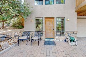 a house with two chairs and a wooden door at Hidden Valley Haven - Unit B in Prescott