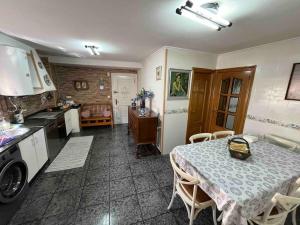 a kitchen with a table and a dining room at Medulillas 2 A solo 2000 m de Las Médulas in Yeres