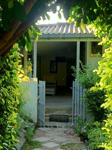 an entrance to a house with a white gate at Green Bird in Mirissa