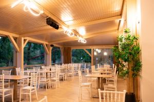 a row of tables and chairs in a banquet hall at Metropol in Baile Felix