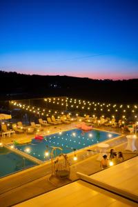 a view of a swimming pool at night at Metropol in Baile Felix