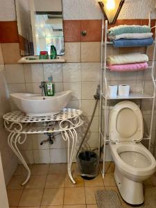 a bathroom with a sink and a toilet at MARIKINA 32 sqm Studio for Transients w WiFi 40 inch TV Parking in Manila