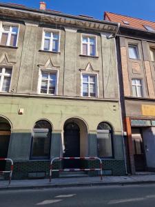 a building on the side of a street at Maestria Apartament 1 in Sulechów