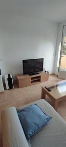 a living room with a tv and a couch at Cumbre Moraig in Benitachell +11 photos