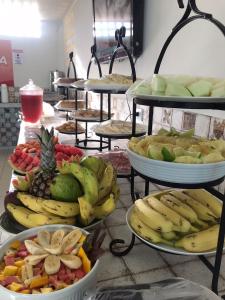 a bunch of plates of fruit on a table at Pousada Império do Cangaço in Piranhas