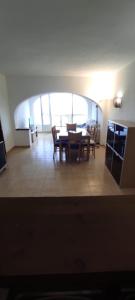 a dining room with a table and chairs in a room at Cumbre Moraig in Benitachell