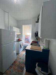 a kitchen with a white refrigerator and a sink at Ysabel in New York