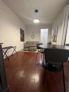 a living room with a table and chairs and a couch at Ysabel in New York