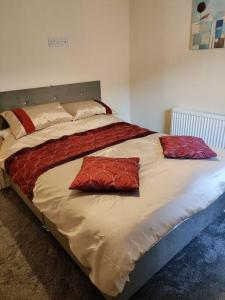 a bed with two pillows on it in a bedroom at Droitwich Spa centre apartment in Droitwich