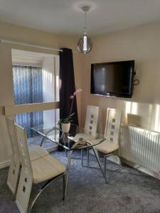 a dining room with a glass table and chairs at Droitwich Spa centre apartment in Droitwich