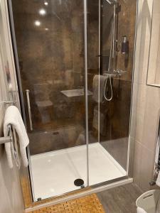 a shower with a glass door in a bathroom at Rose and Crown in Poole