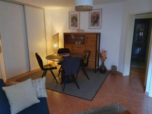 a living room with a table and chairs at Liten Tur ' N in Sélestat