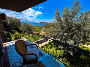 d'un balcon avec un banc et une vue sur l'océan. dans l'établissement Assos Longevity Hotel, à Sokakagzi