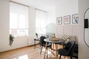 a living room with two tables and chairs at La Capsule - Appartement Design et Cosy in Cambrai