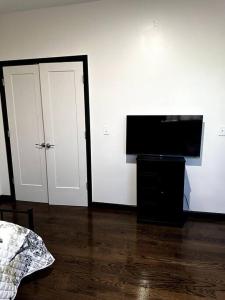 a living room with a flat screen tv next to a door at Duplex Apartment In Bayonne NEW JERSEY. up to 4 peoples. in Bayonne