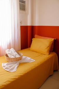 a room with a bed with two baskets on it at Axé home - Apartamento conceito em Salvador in Salvador