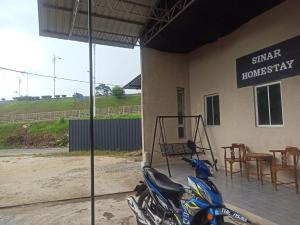 a motorcycle parked in front of a building at Sinar Homestay in Kuala Terengganu