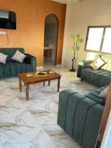 a living room with a couch and a coffee table at مزرعة الشفق in Ad Dimnah