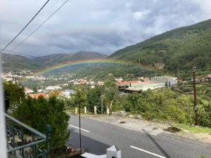 a rainbow on the side of a road at A Casa da Rapariga de Cabelo Azul in Manteigas