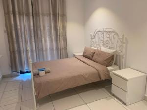 a bedroom with a bed with a metal bed frame at Royal Luxury Apartments in Accra